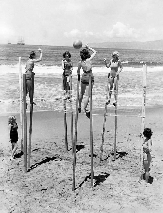 Woman playing volleyball on stilts at Venice Beach, CA, US in 1942.