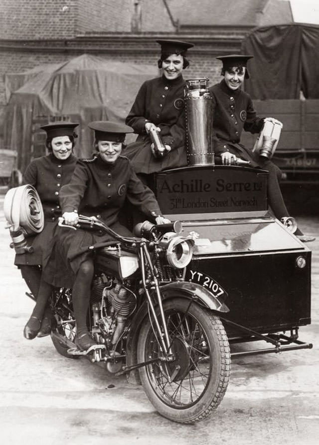 A female firefighting team on a special converted motorcycle in London, England in 1932.