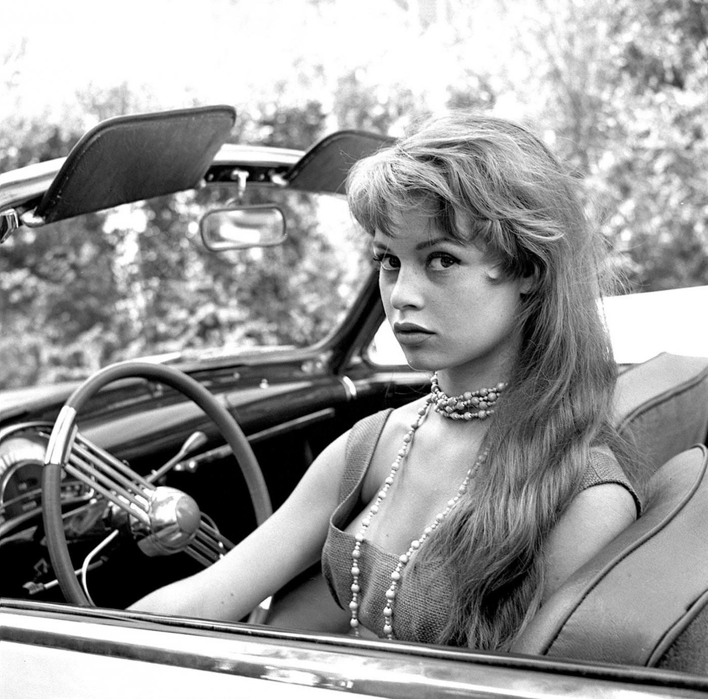 Brigitte Bardot in her car, 1950s.