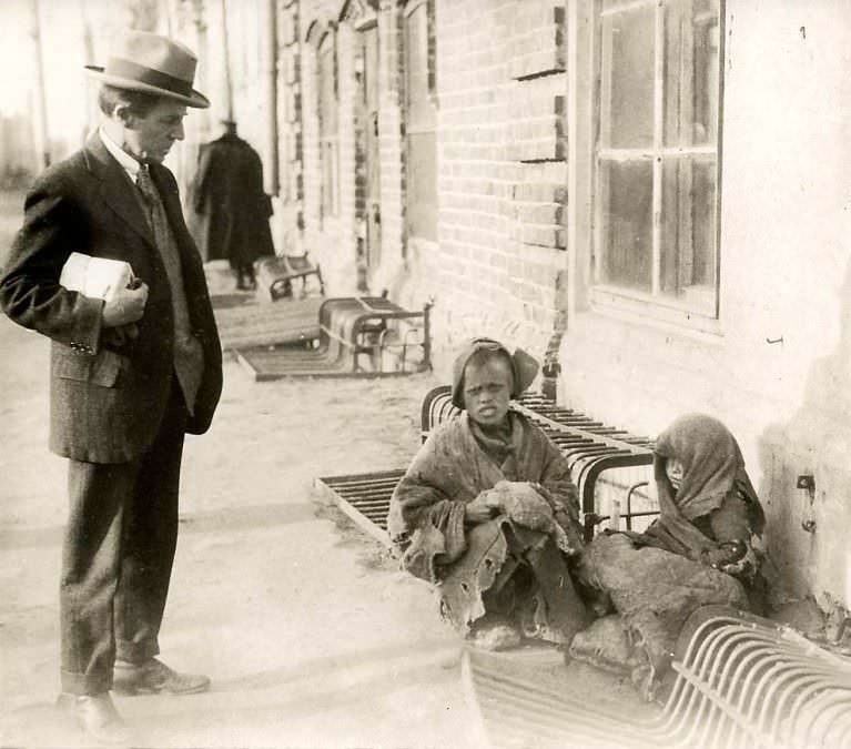 A man looks at homeless children on the streets of Moscow, Russia in 1934.