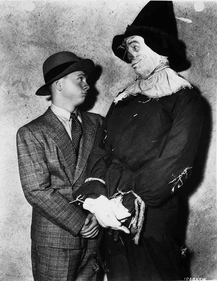 Mickey Rooney visits with Ray Bolger as the Scarecrow on the set of the Wizard of Oz, 1939.