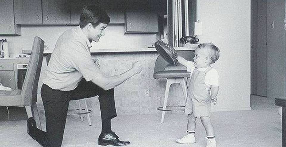 Here's a dapper young Bruce Lee with his son Brandon, 1966.