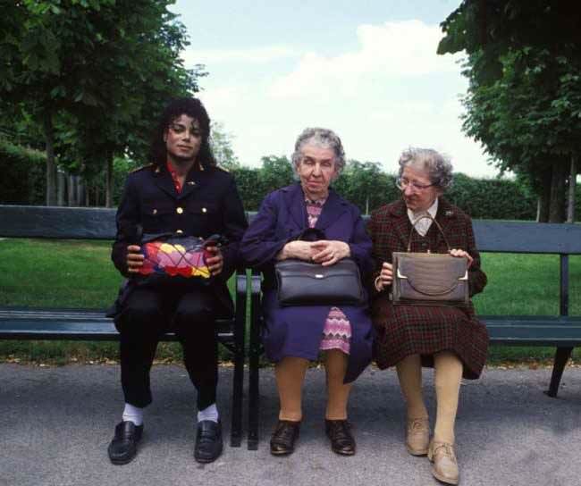 Michael Jackson with two old ladies all clutching their handbags while sitting on a park bench. MJ's bag wins.