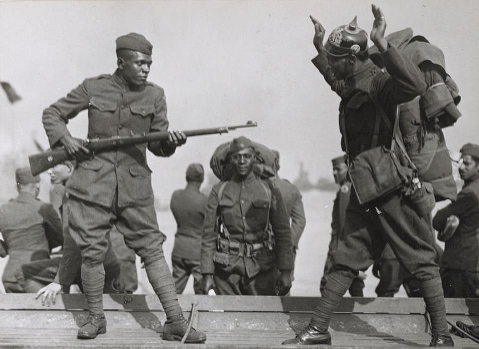 Black American soldiers goof off in France during WWI in 1917. When the US entered WWI, only 4 black soldier units known as 'colored' units existed in the US military. President Woodrow Wilson called up volunteers, including setting a quota for black soldiers. Within a week of the first request, 1 million black men volunteered for the army, forcing them to stop accepting applications as the massive number of volunteers more than quadrupled the US Army's desired quota. Some 800,000 black volunteers were at first denied. By wars end, around 370,000 black American soldiers took part in WWI, many in heavy engagements.