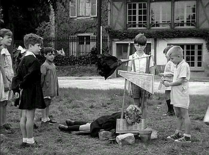 Kids pretend to guillotine a criminal in some kind of a game in France, 1959.