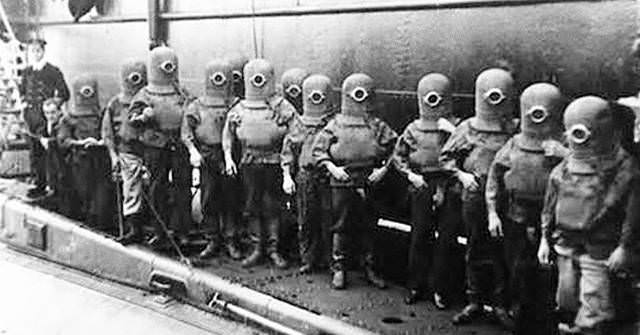 Divers from a German submarine crew prepare to go underwater for training in 1908.