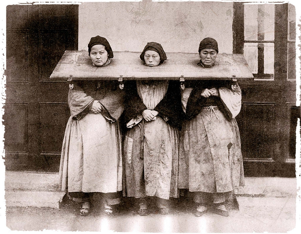 Women being punished in Shanghai, China in 1885.