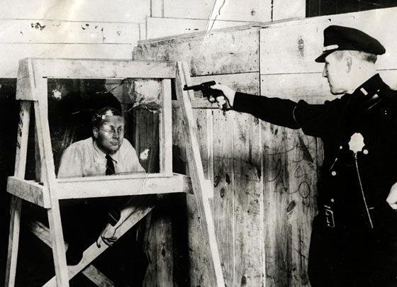 Officers testing bullet proof glass in NYC, US in 1931.