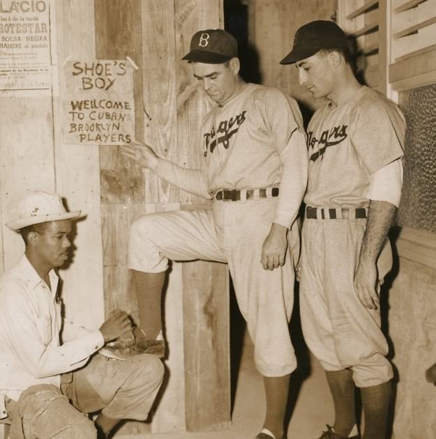 A Brooklyn Dodgers player gets his cleat shined in Havana, Cuba in 1941.