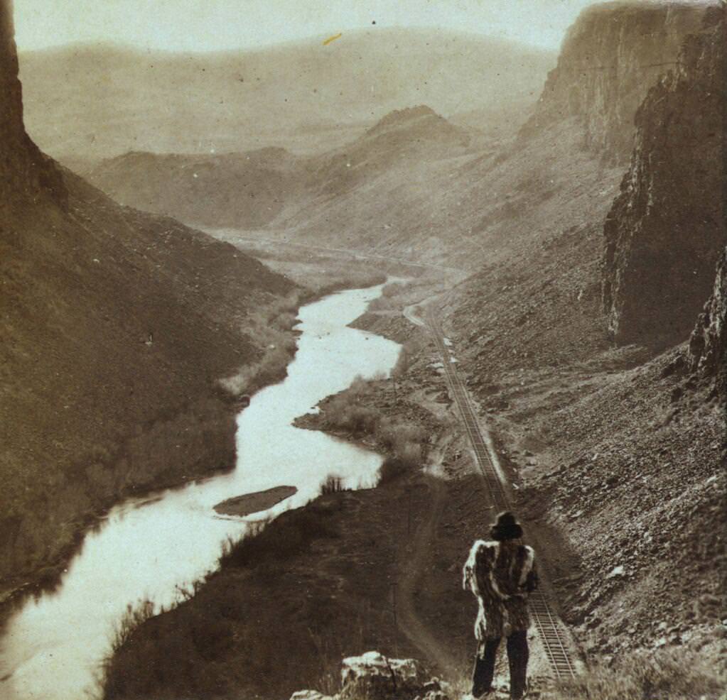 A Native American looks a completed section of the Transcontinental Railroad in Nevada, US in 1868.