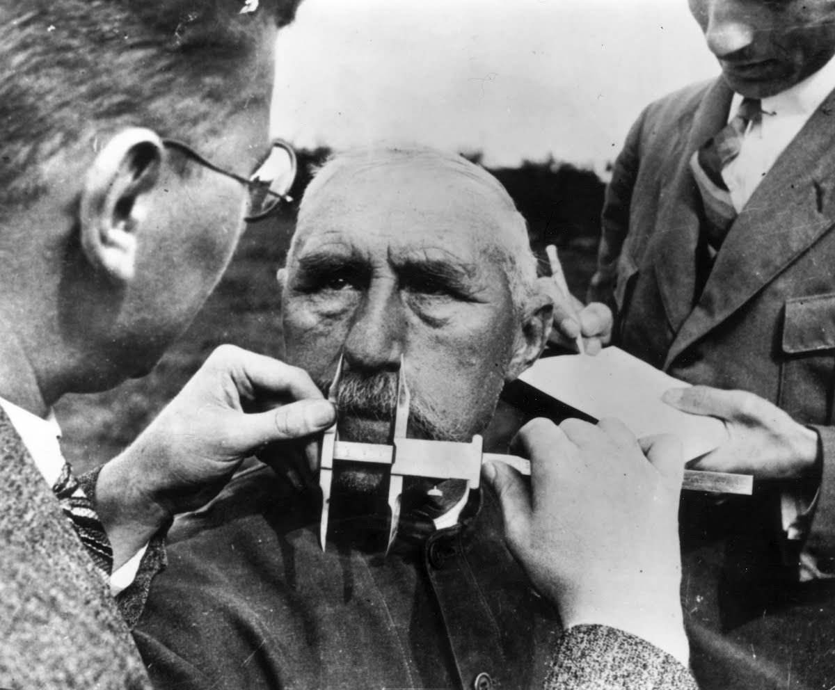 A man who is suspected to be part Jewish has his nose measured during Aryan race determination tests in Germany in 1940.