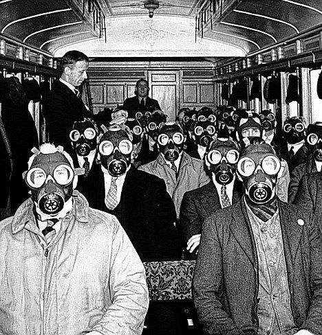 Daily commuters wear gas masks while riding a train in London, England in 1940.