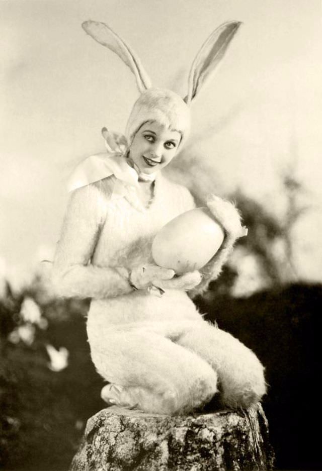 A young Loretta Young poses as the Easter bunny with her egg in the US, 1933.