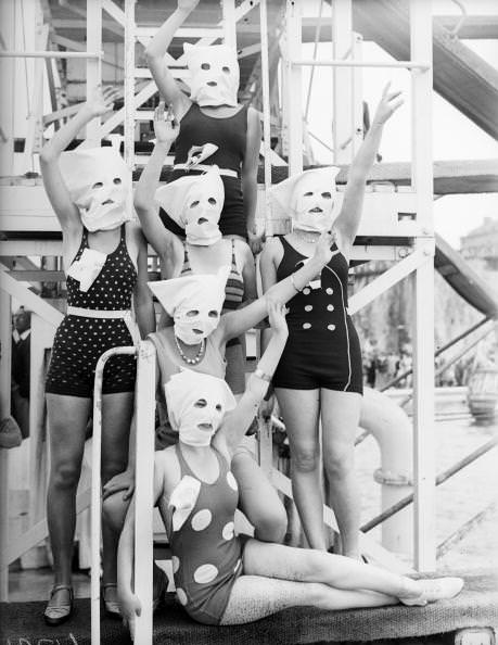 Contestants pose for a picture with bags on their head to make sure zero focus is on their faces before the "Neatest Figure" contest at Margate, England in 1932.