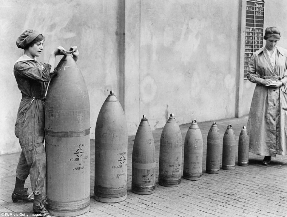 Female munitions workers tighten the top of shells at the National Shell Filling Factory No.6, Chillwell, Nottinghamshire, England during the First World War in 1917.