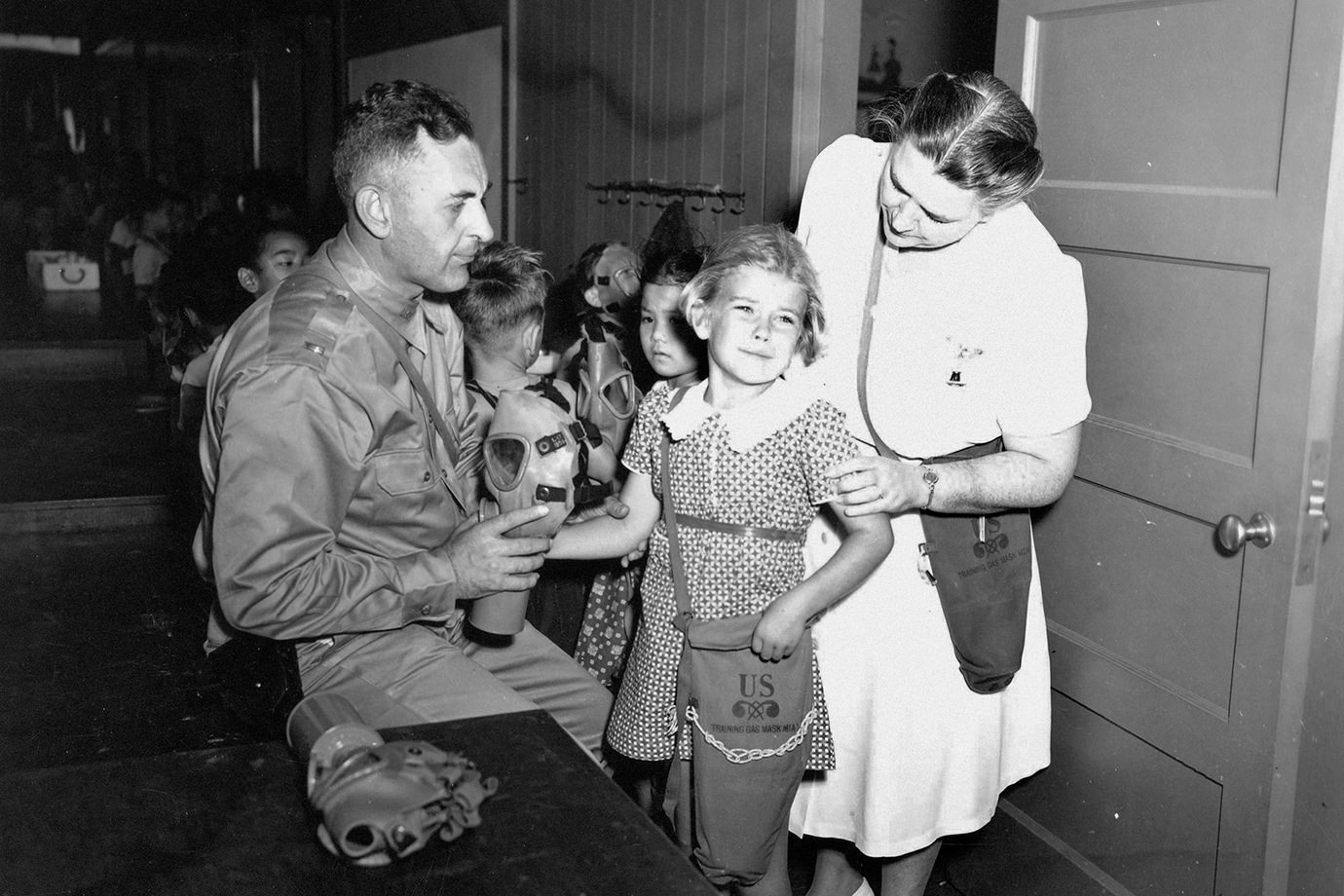 A young student is scared as she gets fitted for a gas mask in a school in Honolulu, Hawaii, US in 1942.