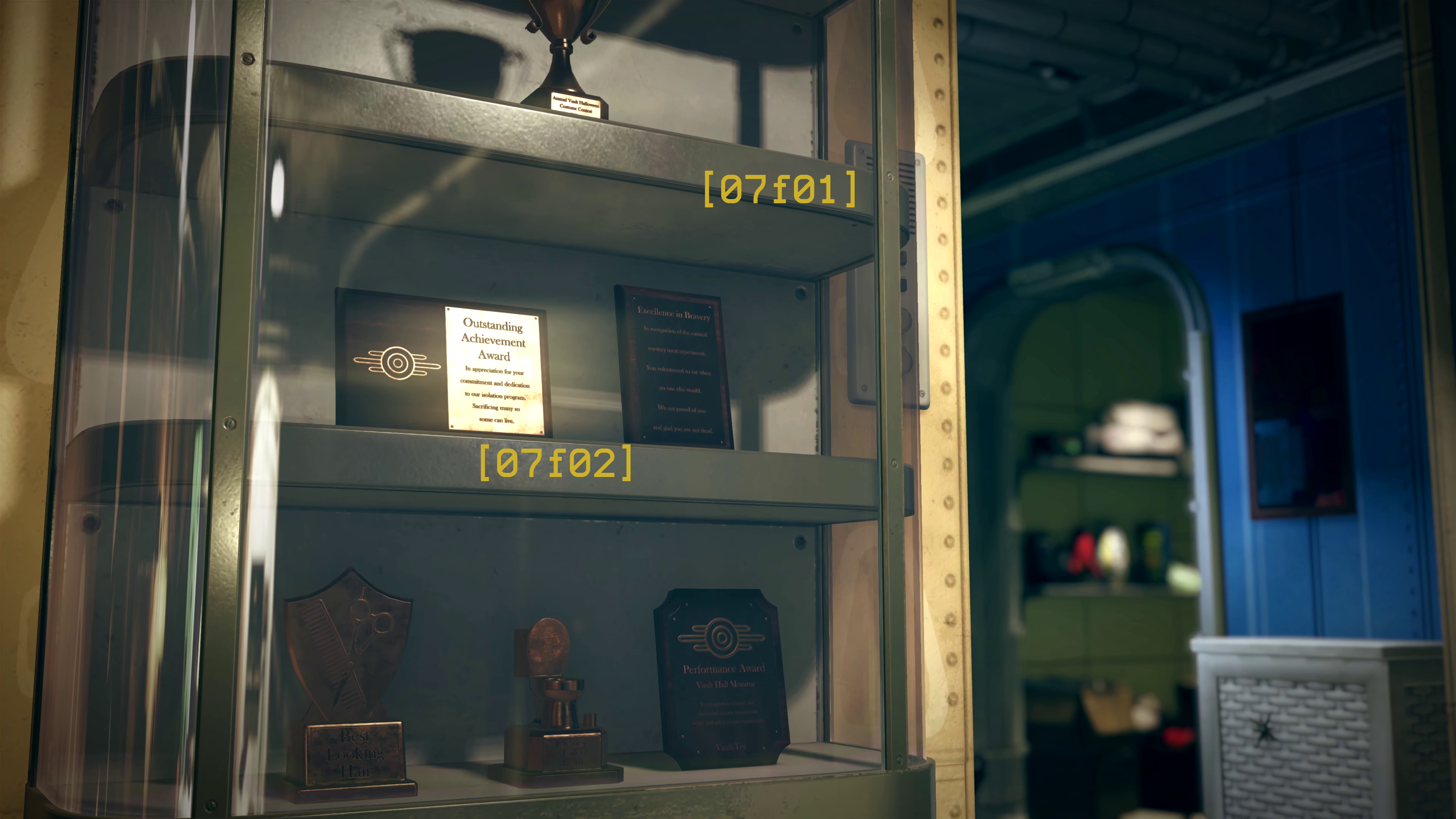 [Screenshot 07] Findings: - [07f01] - Somewhere within the vault, there is a dedicated trophy case. - [07f02] - There is a multitude of awards within the case and some of them are rather peculiar. They read as follows: > (bottom-left): BEST LOOKING HAIR > (bottom-centre): CLEANEST TOILET AWARD (shaped like a toilet) > (bottom-right): Performance Award - Vault Hall Monitor - In recognition of loyal and dedicated service towards the order and safety of our community. - Vault Tec > (middle-left): Outstanding Achievement Award - In appreciation for your commitment and dedication to our isolation program. Sacrificing many so some can live. > (middle-right): Excellence in Bravery - In recognition of the canned mystery meat experiment. You volunteered to eat when no one else would. We are proud of you and glad you are not dead. > (top-middle): Annual Vault Halloween Costume Contest - 1st Place Other pertinent info: - Conclusions: - [07c01_f01] - The existence of a trophy case may serve as yet another indicator as to the age of Vault 76's occupants, given that it's common practice for US high schools to have trophy cabinets not unlike this one.