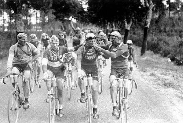 Smoking a cigarette while riding in the Tour de France, 1920s.