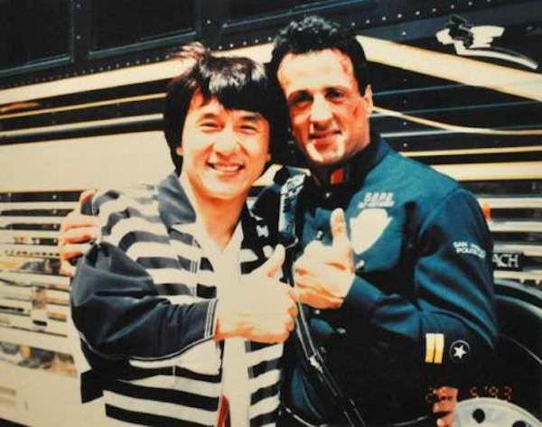 Jackie Chan takes a picture with Sylvester Stallone when Chan showed up on the set of Demolition Man in 1993.