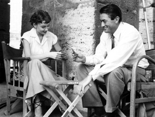Audrey Hepburn and Gregory Peck play cards in between scenes of Roman Holiday in 1953.