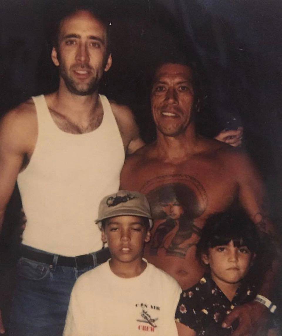 Nicolas Cage takes a picture with his costar Danny Trejo and his thrilled kids Gilbert Trejo and Danielle Trejo on the set of Con Air in 1997.