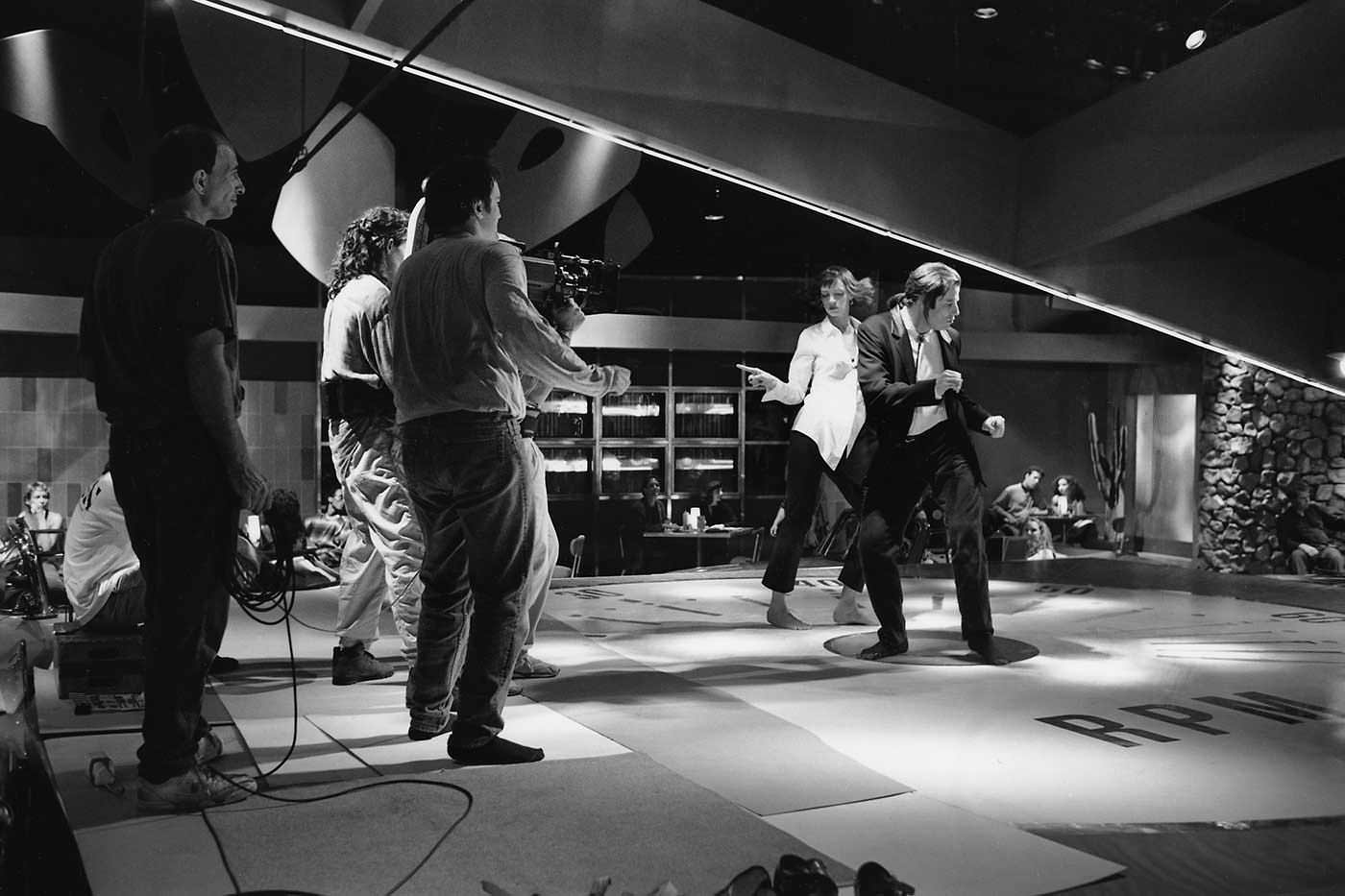 Quinten Tarantino (center) dancing along with John Travolta and Uma Thurman during a scene in Pulp Fiction in 1994.
