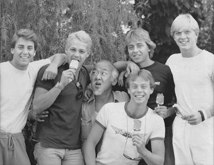 Tony O’Dell, Chad McQueen, Pat Morita, Rob Garrison, Ron Thomas and William Zabka eating ice cream on the set of The Karate Kid in 1984.