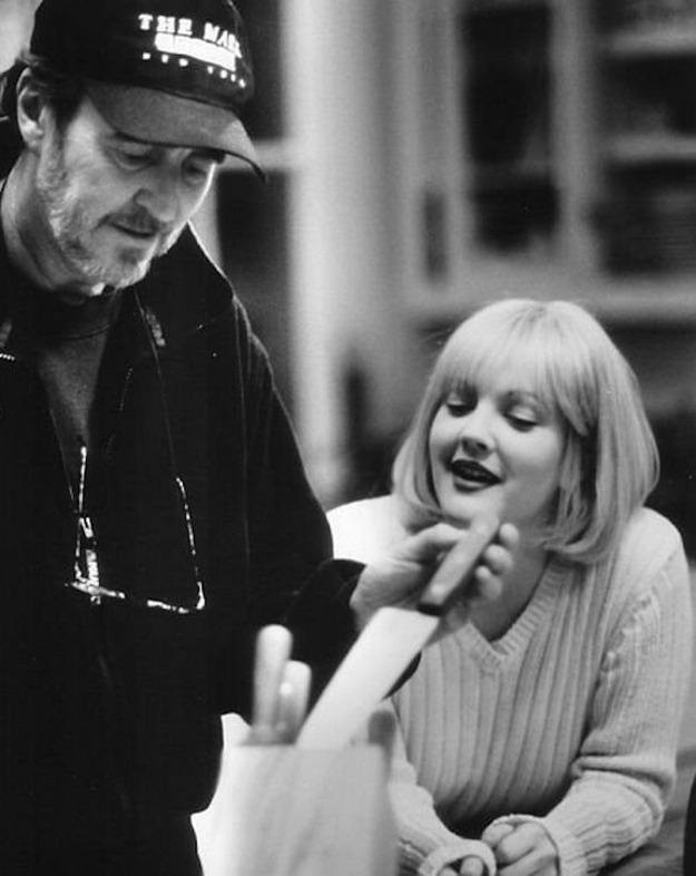Wes Craven showing Drew Barrymore how he wants her to handle a scene much to her delight for the film Scream in 1996.