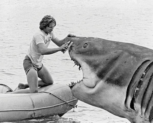 A special effects employee cleans the face of the shark in the film Jaws in 1975.