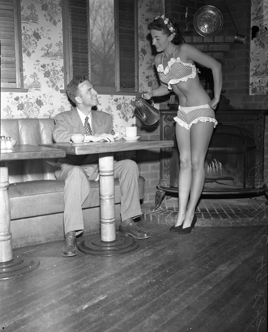 Pat Hall AKA Miss 7-Cent Cup of Coffee serving William E. Kinman coffee while wearing a bikini in LA, US in 1950.