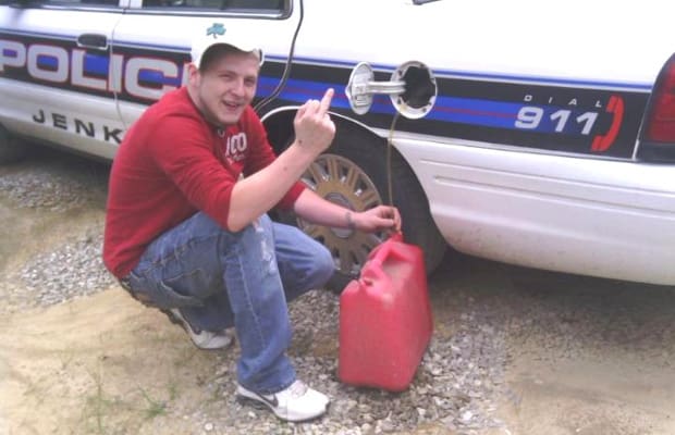 guy siphoning gas from cop car