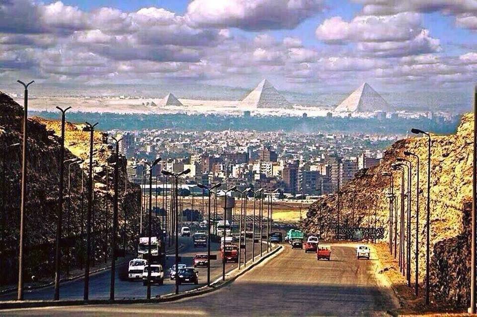 The Great Pyramids of Giza as seen from a street in Cairo.