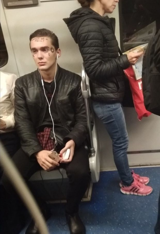 Man with face tattoos on the train