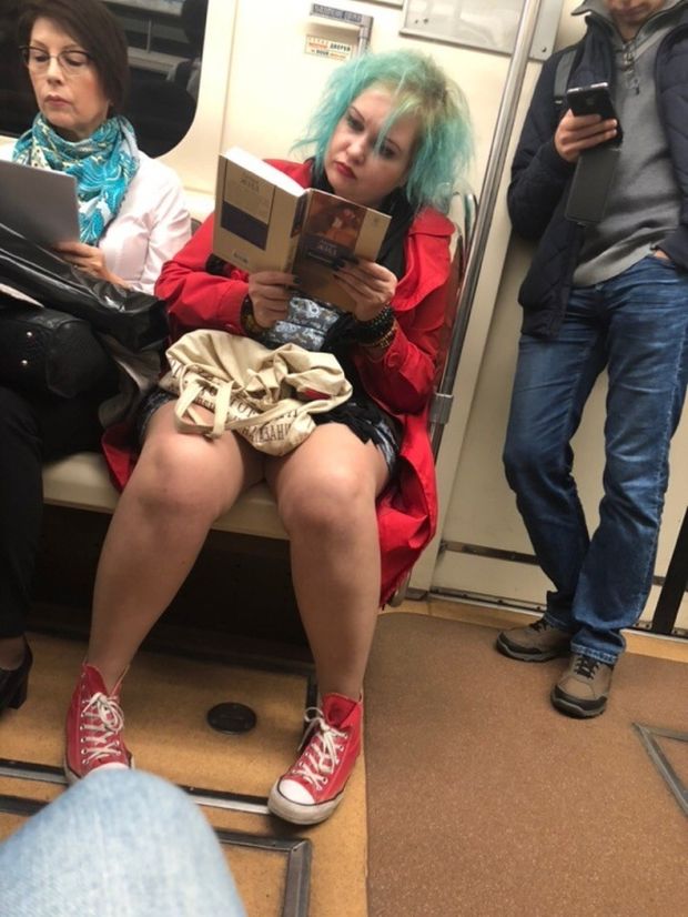 Colored hair woman on the train reading