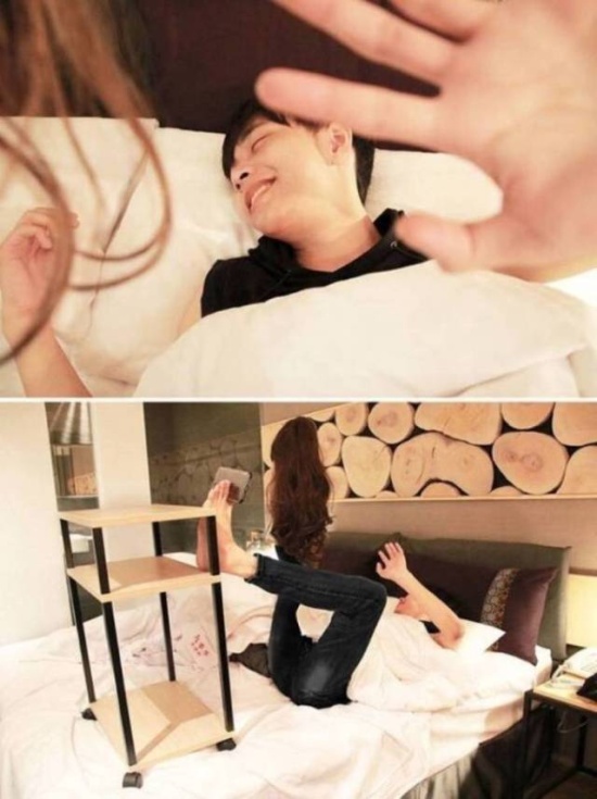 Girl waking up boyfriend. Guy using his feet to take pic.