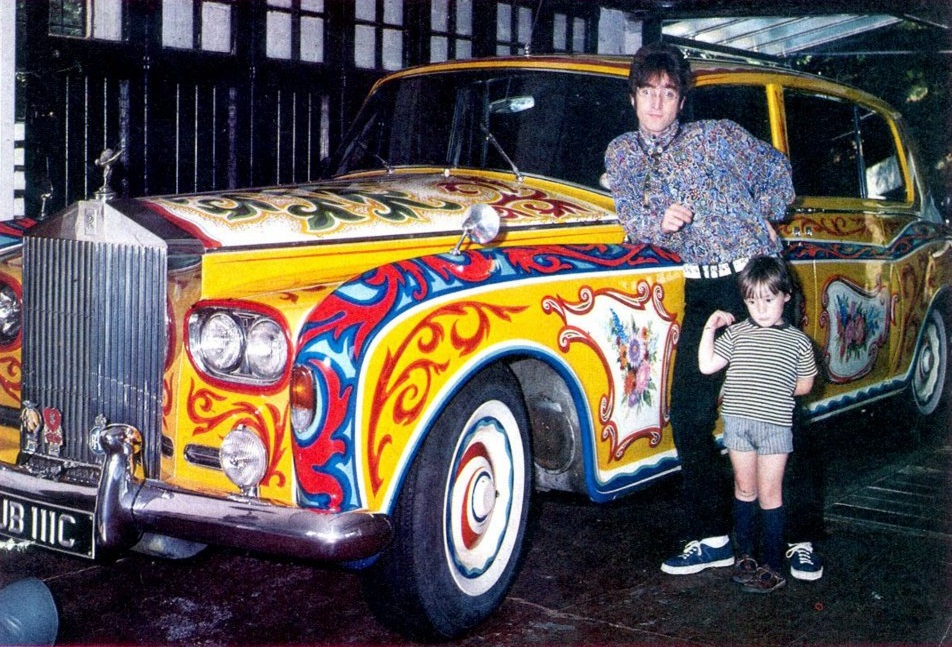 John Lennon​ and his son Julian Lennon​ with a Rolls Royce Phantom V (custom paint job) in his garage, 1968.