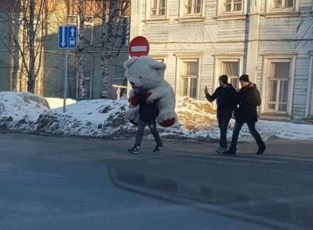 russia - man carrying a huge teddy bear