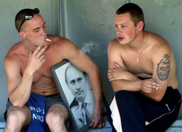 russia - man smoking and holding a pic of putin