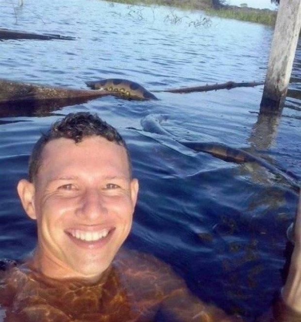 man takes selfie with anaconda