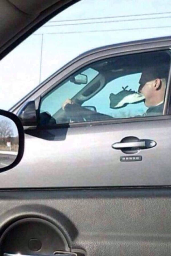 wtf pics - guy driving with shoe in mouth