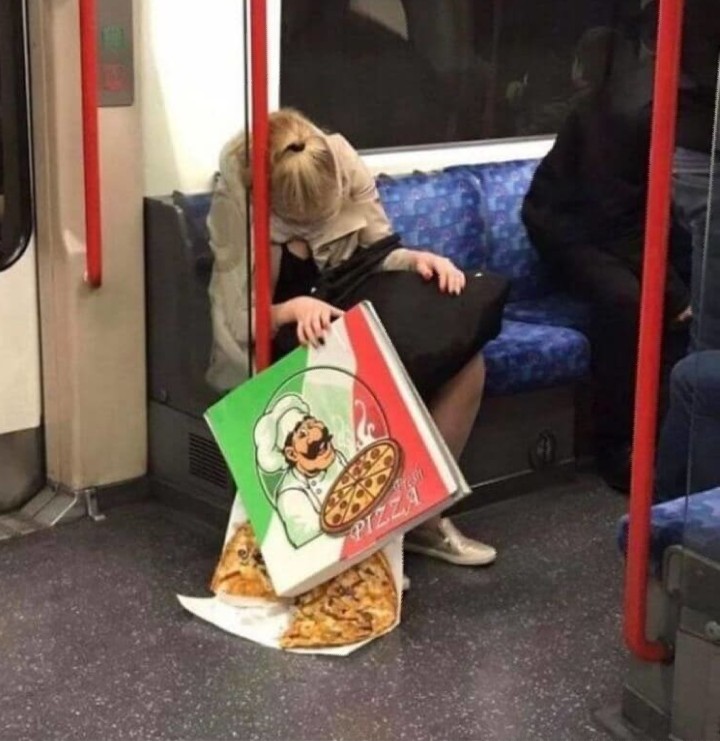 A woman on the bus who dropped her pizza.