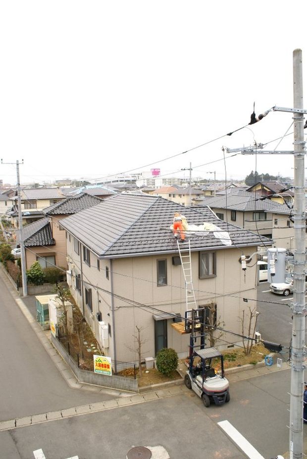 person on a roof of a house