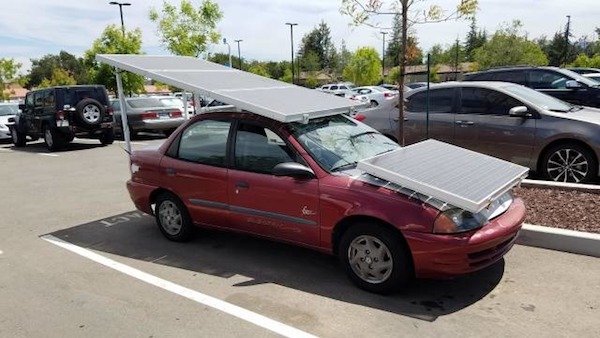 red car with massive solar panels attached.
