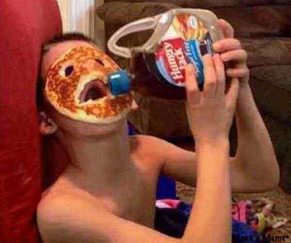 kid with pancake on face - Hungry