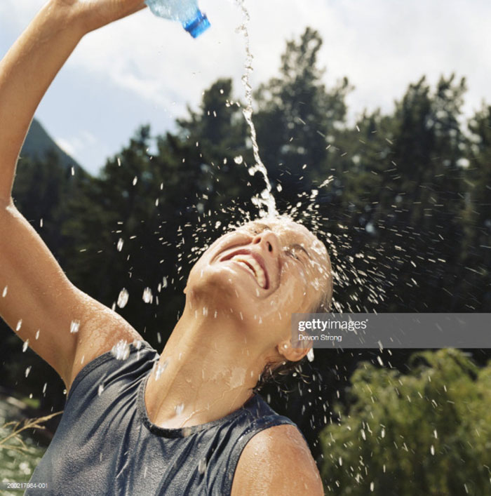 stock image women pouring water - gettyimages Devon Strong 200017064001