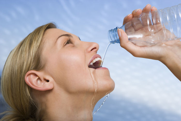 woman struggles to drink water