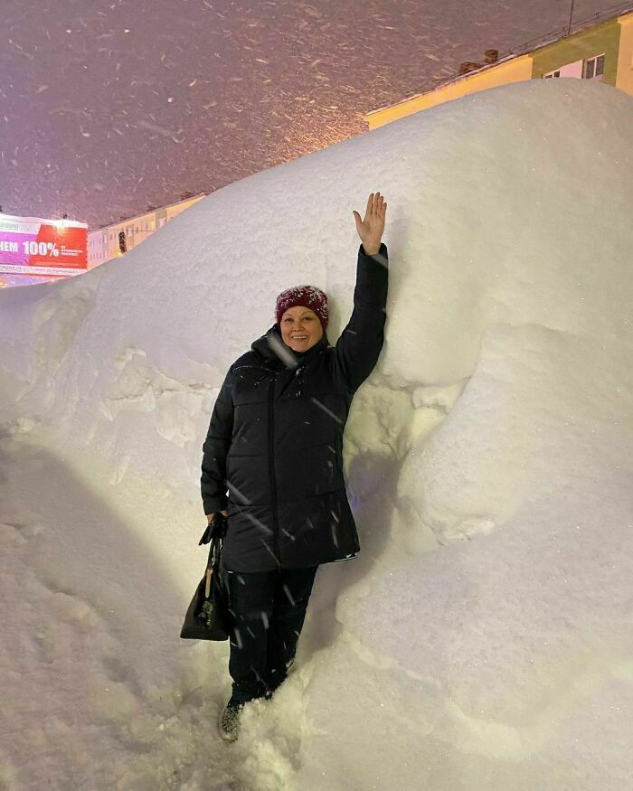 cool winter pics -- woman standing next to wall of snow