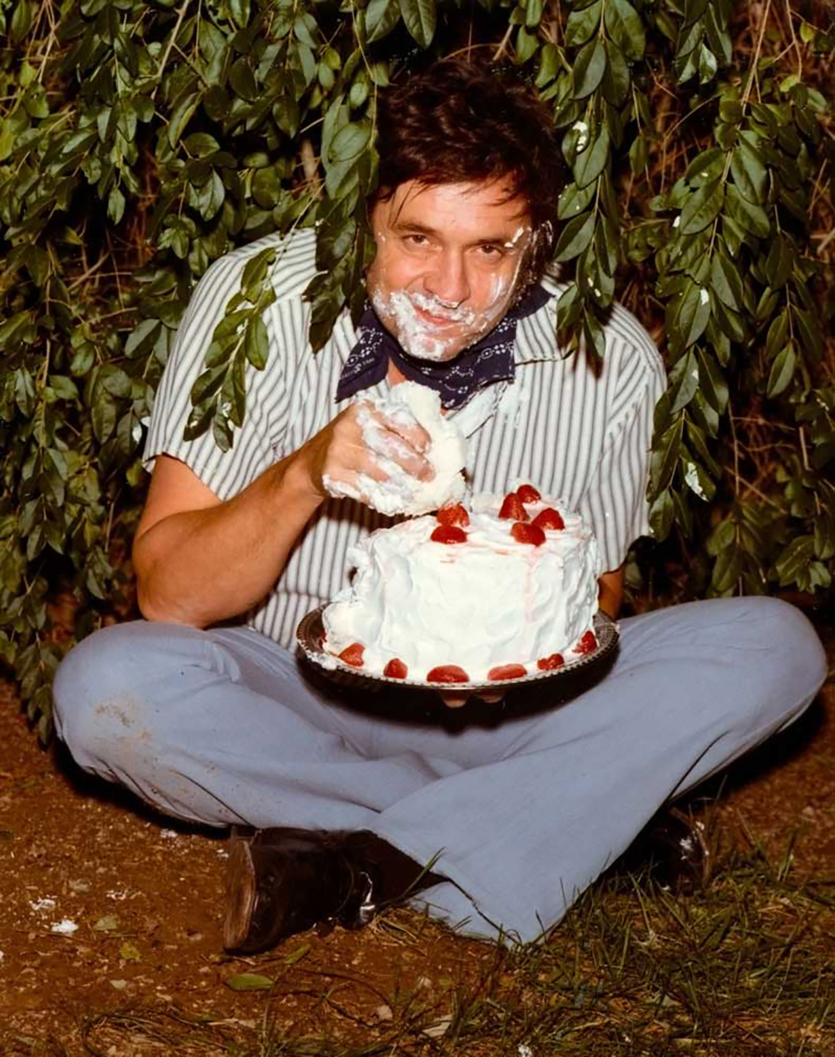 Johnny Cash eating a cake in the early 1970s.