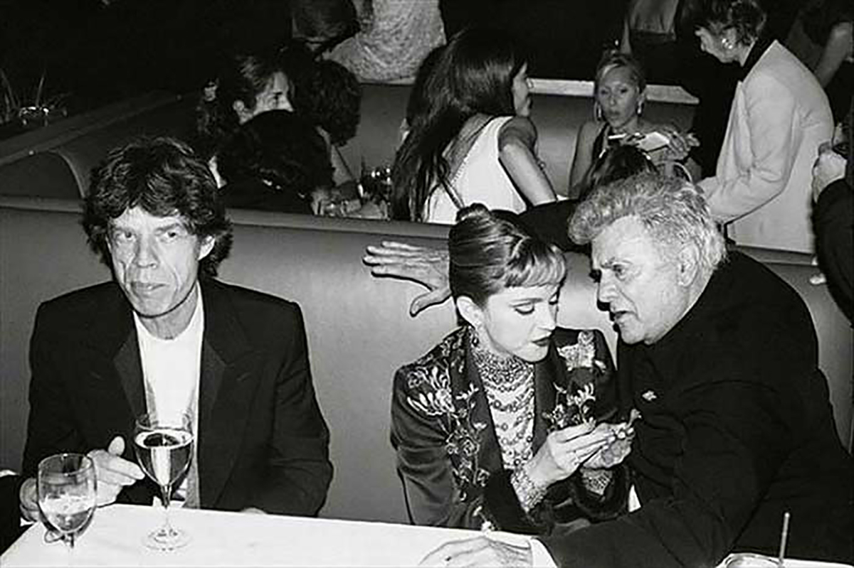 Mick Jagger appearing annoyed at Tony Curtis, 1995.