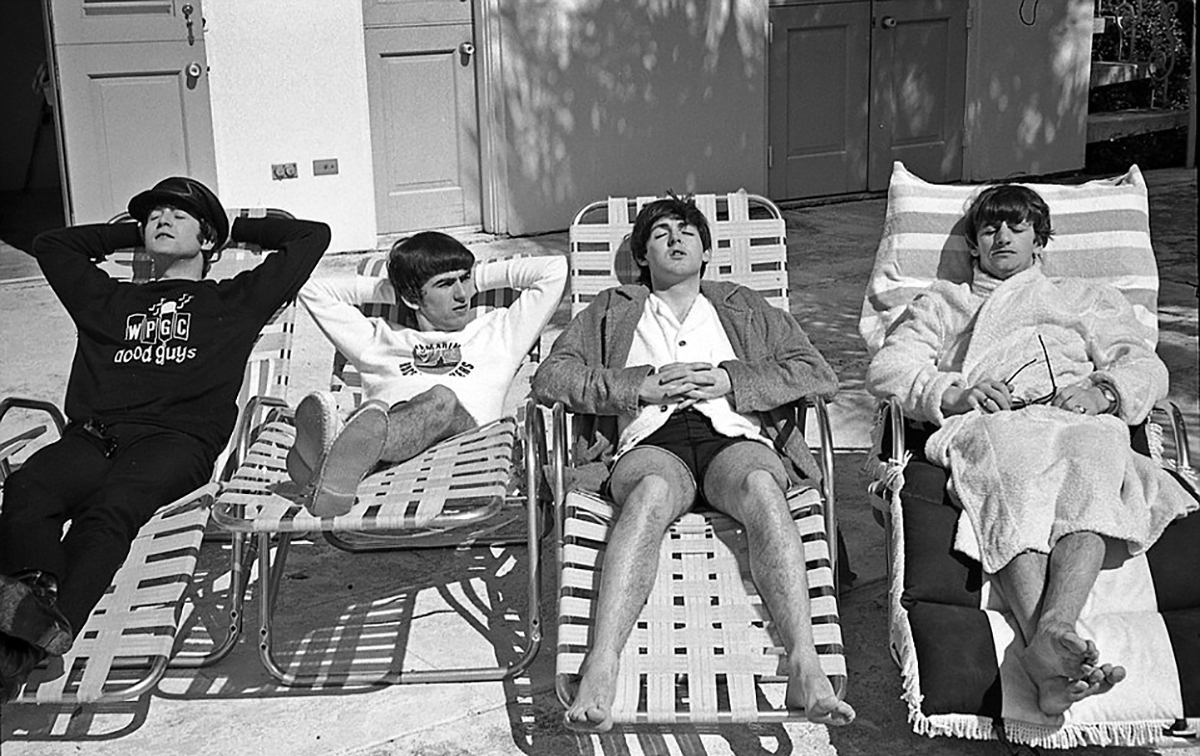 The Beatles relaxing in the sun in 1964.